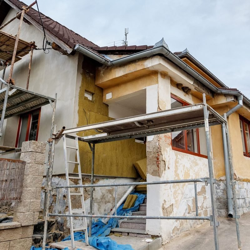 repaired rural house, fixed facade, insulation and painted to green  color witg swimming pool